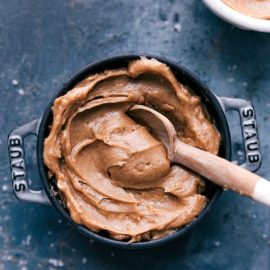 The creamy spread in a small pot with a wooden spoon.