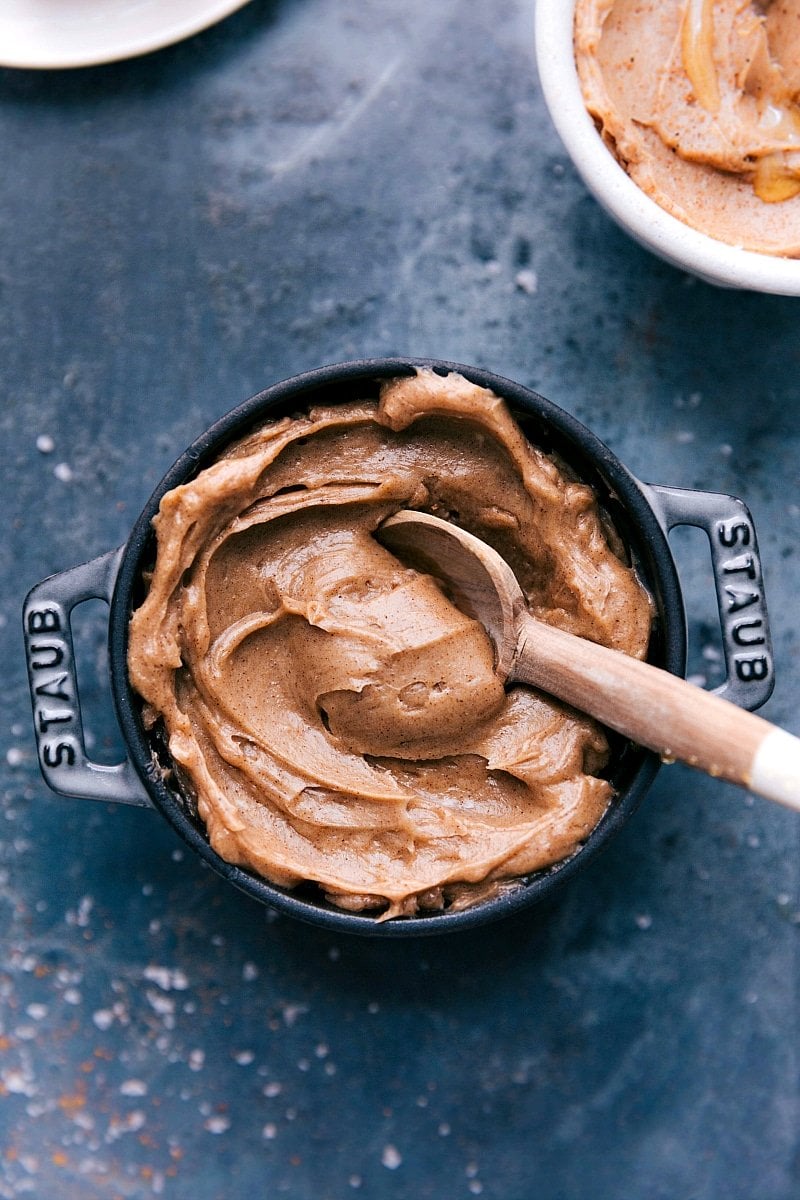 The creamy spread in a small pot with a wooden spoon.