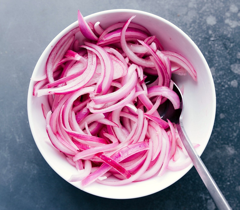 Overhead image of pickled onions in a bowl.