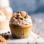 Chocolate chip cupcakes topped with rich icing and sprinkled with chocolate shavings.