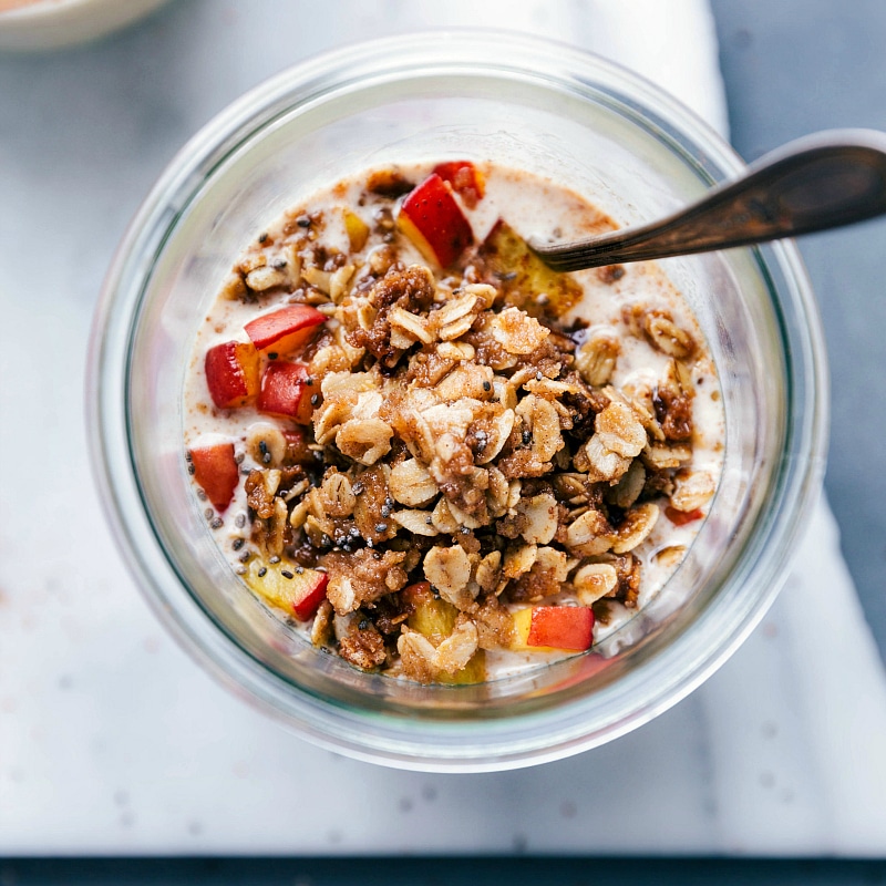 Delicious and finished peach cobbler overnight oats in a bowl, showcasing the streusel topping.