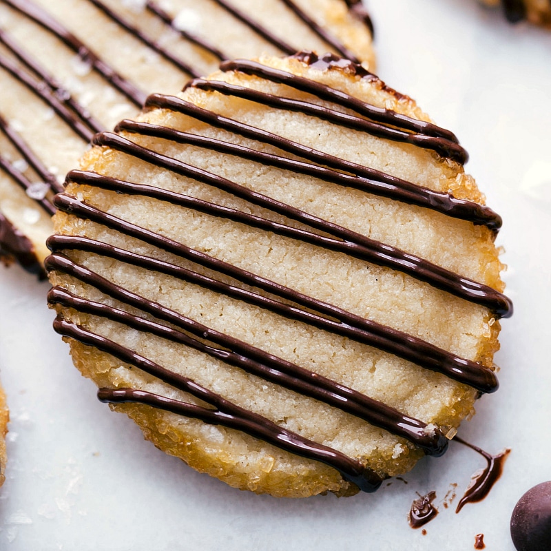 Closeup shot of Shortbread Cookies with a chocolate drizzle.