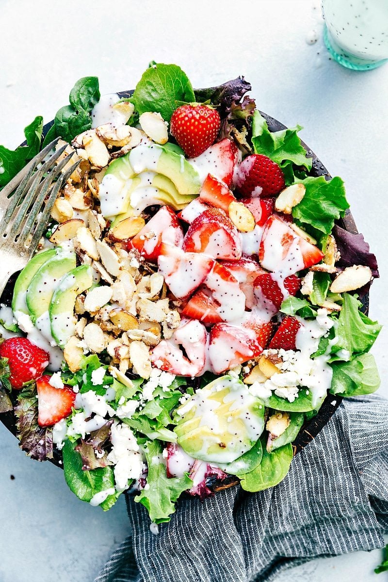 Strawberry poppy seed salad in a large bowl, showcasing vibrant fruits and fresh greens.