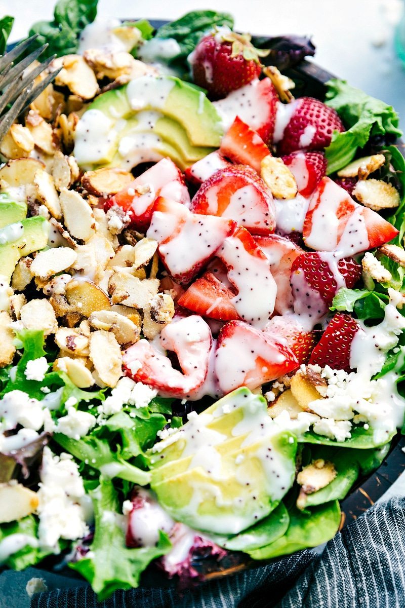 Fully dressed strawberry spinach salad with poppyseed dressing, vibrant and ready to serve.