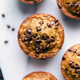 Gluten-free banana muffins with chocolate chips, freshly baked and steaming, ready to be enjoyed.