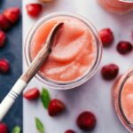 Refreshing lemon berry slush in a glass with a spoon, ready to enjoy.