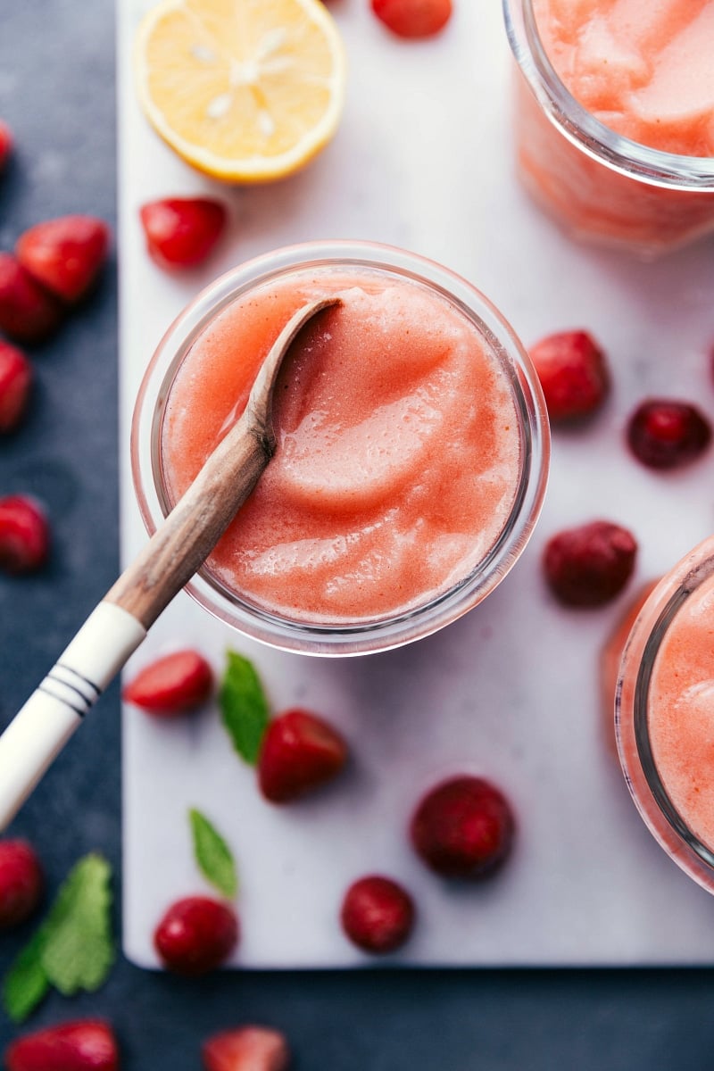 Refreshing lemon berry slush in a glass with a spoon, ready to enjoy.