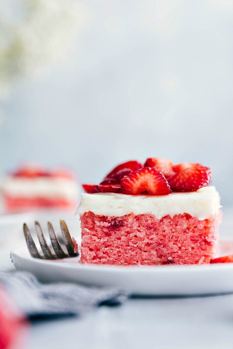 A slice of Strawberries and Cream Cake on a plate.