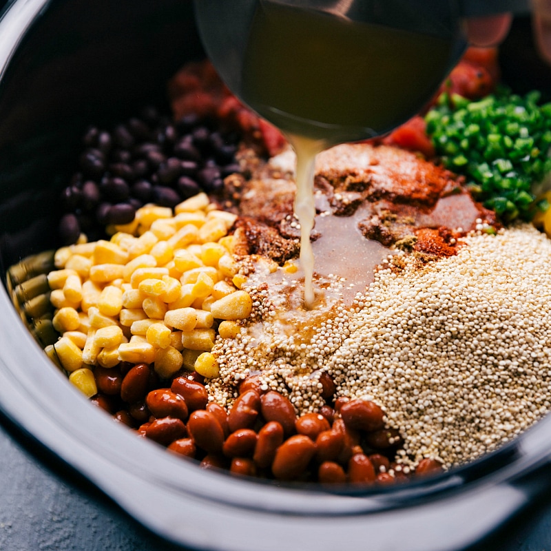 Adding vegetable stock to Crockpot Quinoa.