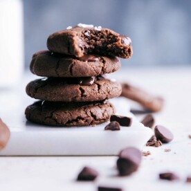 Healthy chocolate chip cookies stacked with a bite out of one of them.