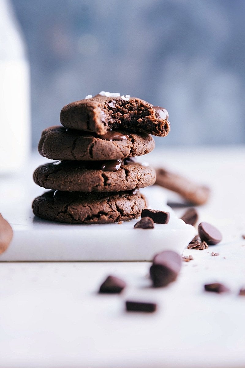 Healthy chocolate chip cookies stacked with a bite out of one of them.