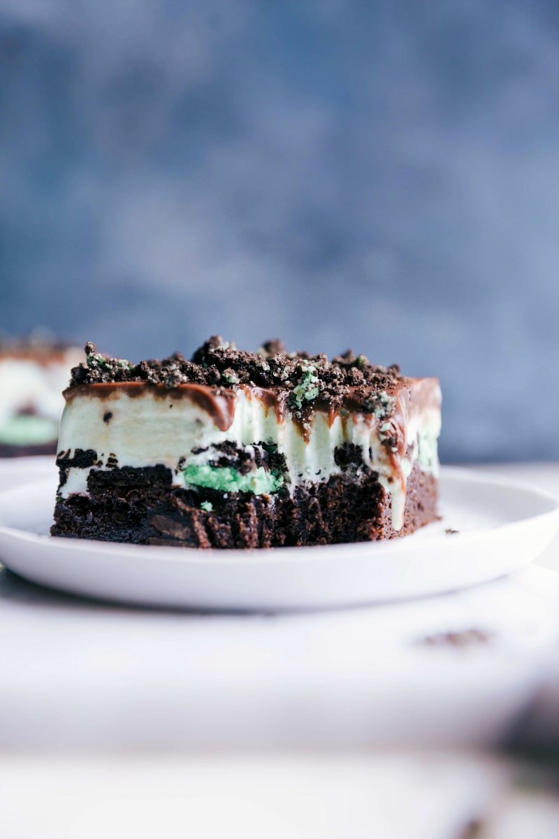 Mint chocolate chip ice cream bar with a revealing bite, showcasing its delicious layered composition.