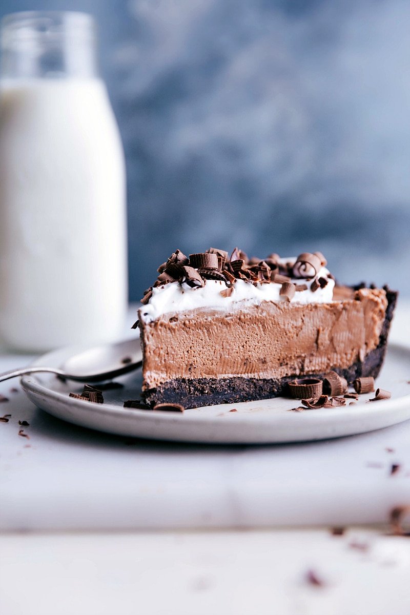 Image of a slice of Nutella Pie on a plate with a spoon, ready to be eaten.