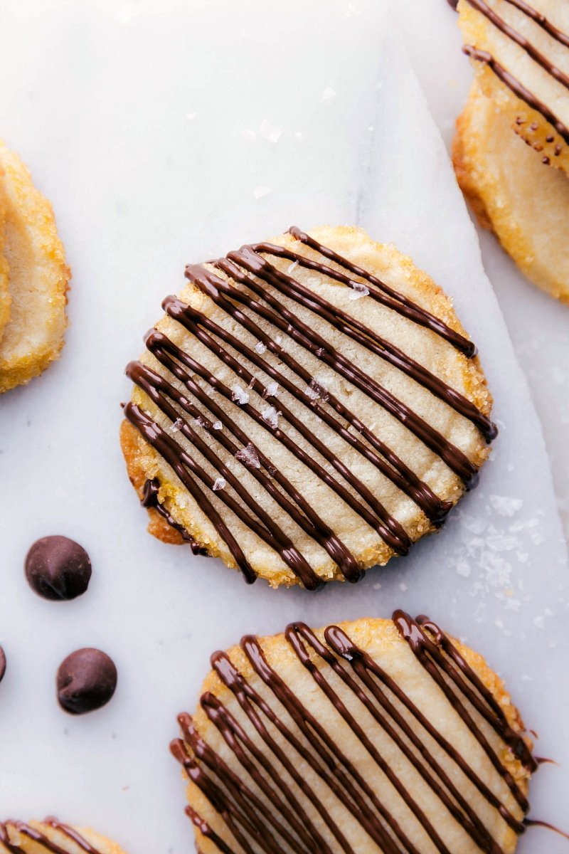 View of Shortbread Cookies with chocolate drizzled on top.
