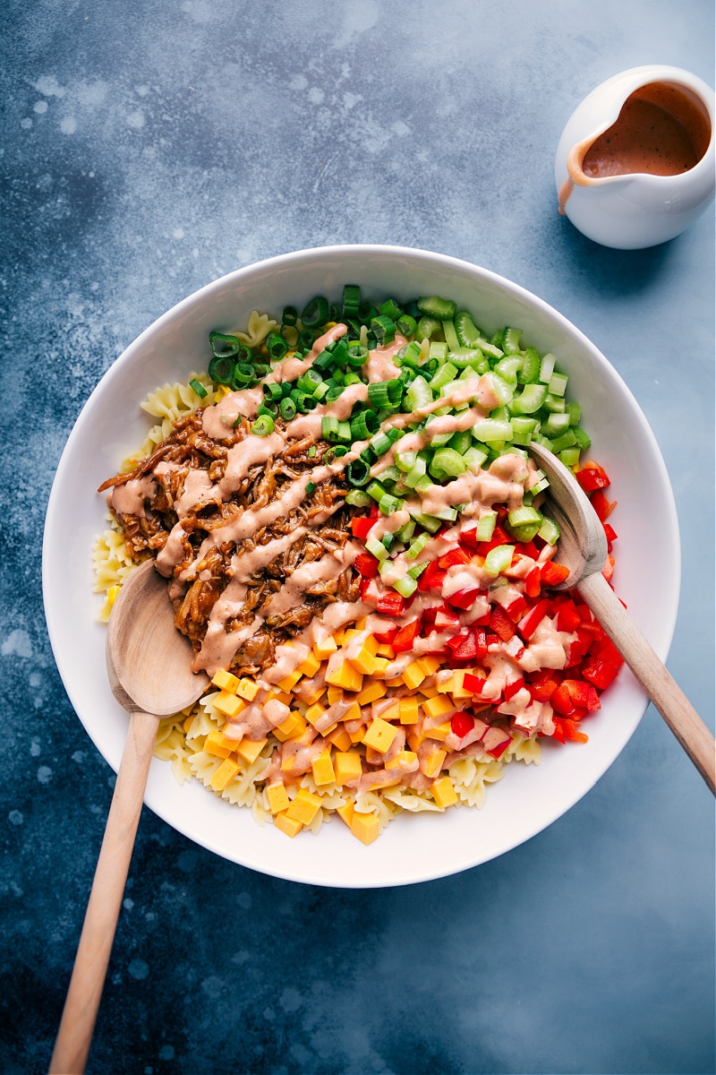 The Best BBQ Pasta Salad Recipe BBQ Pasta Salad in a large bowl drizzled with the creamy dressing.