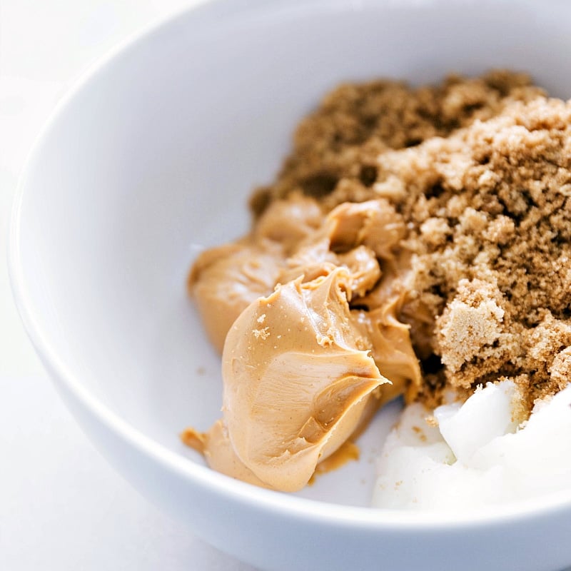 Image of the peanut butter, coconut oil, and sugar in a bowl for these Flourless Monster Cookies.