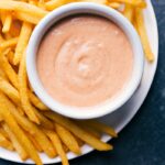 A plate of fry sauce with french fries on the side.
