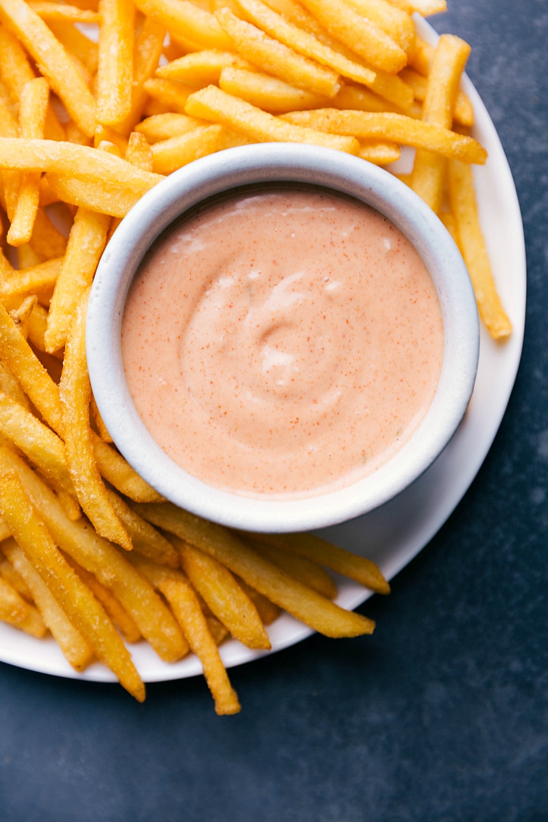 A plate of fry sauce with french fries on the side.