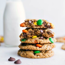 Healthy Monster Cookies stacked on top of each other with one broken in half showing off the middle.