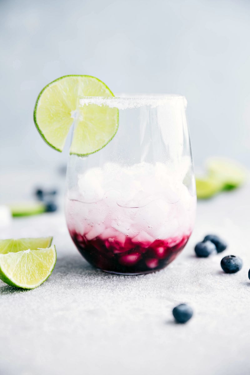 A delicious blueberry mandarine-lime beverage. This spritzer is non-alcoholic made with a sugared blueberry base and a mandarine-lime sparkling water. I chelseasmessyapron.com