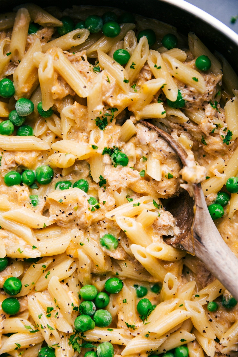 Overhead image of Tuna Pasta in a skillet with a spoon scooping some of it up.