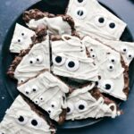 A plate displaying mummy bark, a cute and delicious festive treat, perfect for Halloween or other special occasions.