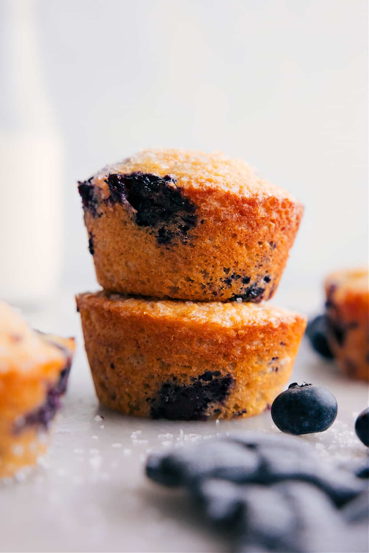 Healthy Blueberry Muffins stacked on top of each other.
