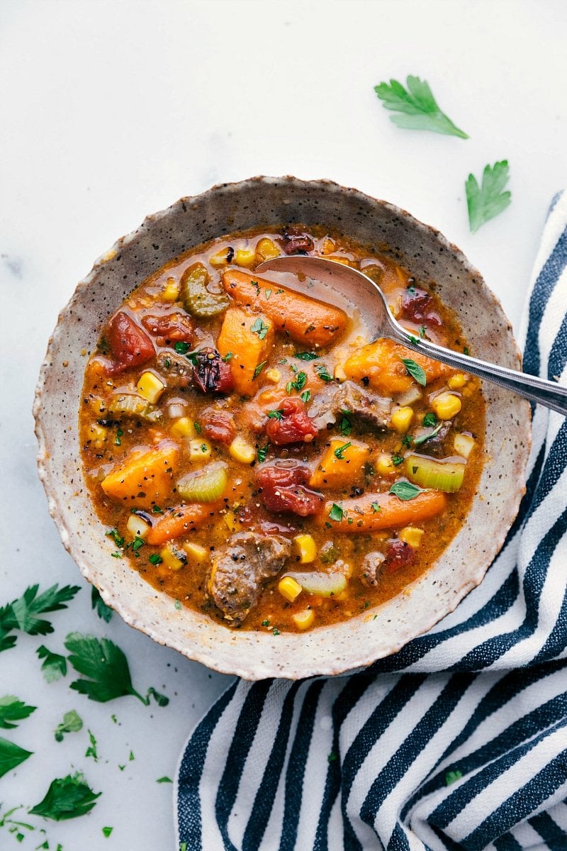 Overhead image of the sweet potato stew with a spoon in it, the best healthy weeknight crockpot meals