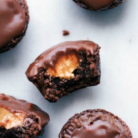 Peanut butter brownie bites with a bite taken out, revealing a melting peanut butter center.