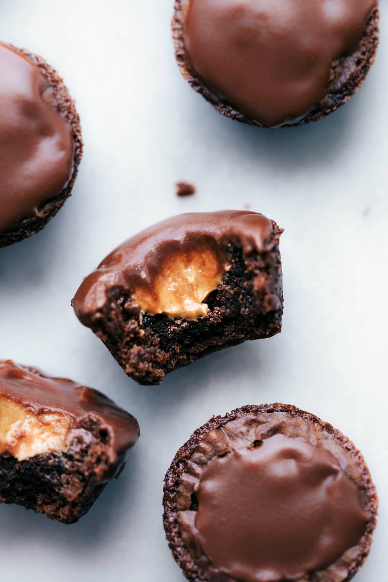 Peanut butter brownie bites with a bite taken out, revealing a melting peanut butter center.