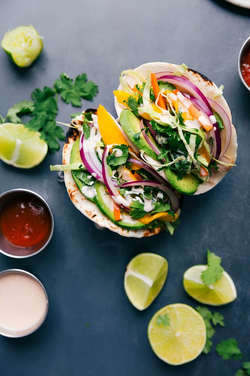 Asian chicken tacos stuffed with chicken, vegetables, and a complementary sauce, ready to be enjoyed.