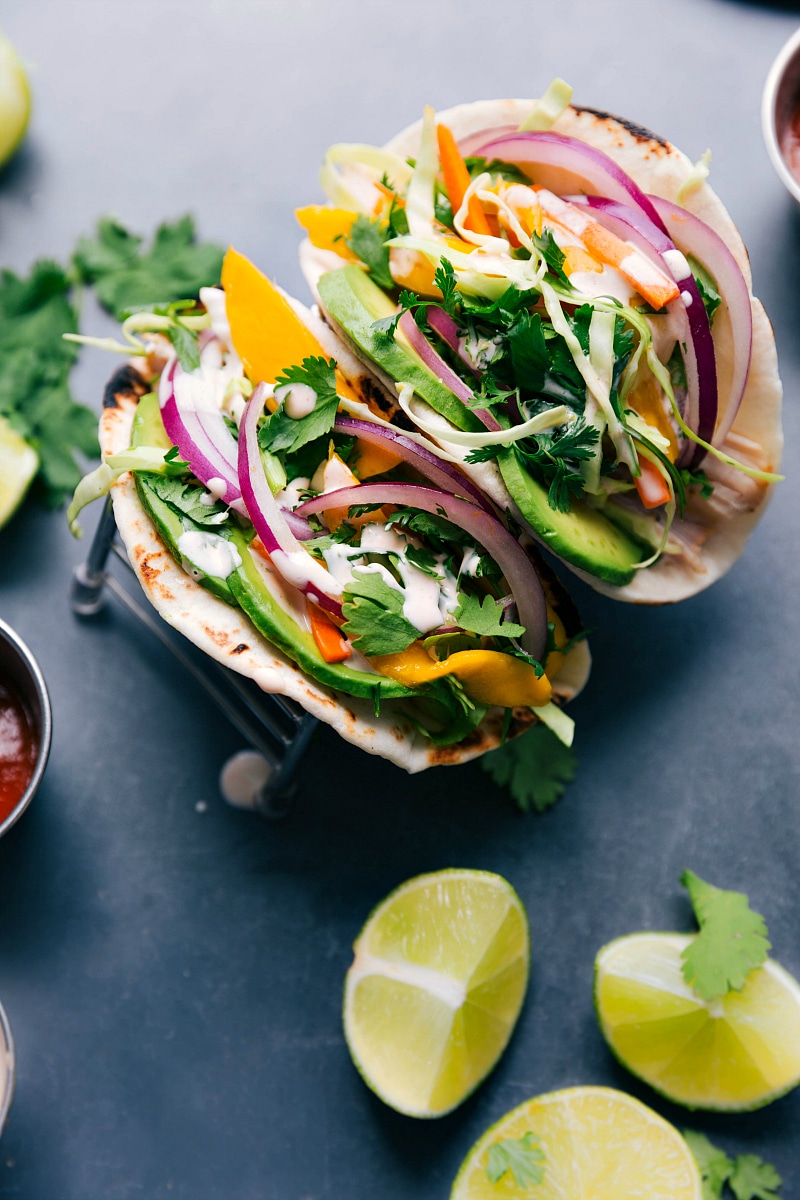 Overhead view of two Asian Chicken Tacos, complete with chicken, slaw and sauce.