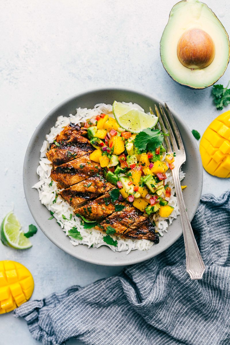 Bowl of cilantro lime chicken with mango avocado salsa served over cilantro lime rice