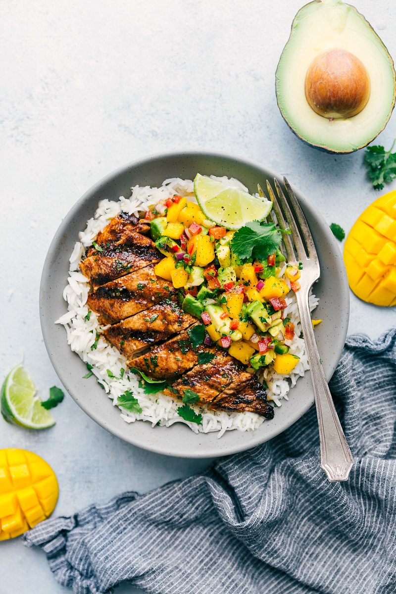 Bowl of Cilantro-Lime Chicken with mango avocado salsa, served over cilantro-lime rice.