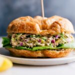 Avocado tuna salad served in a croissant, a delicious sandwich ready to be enjoyed.