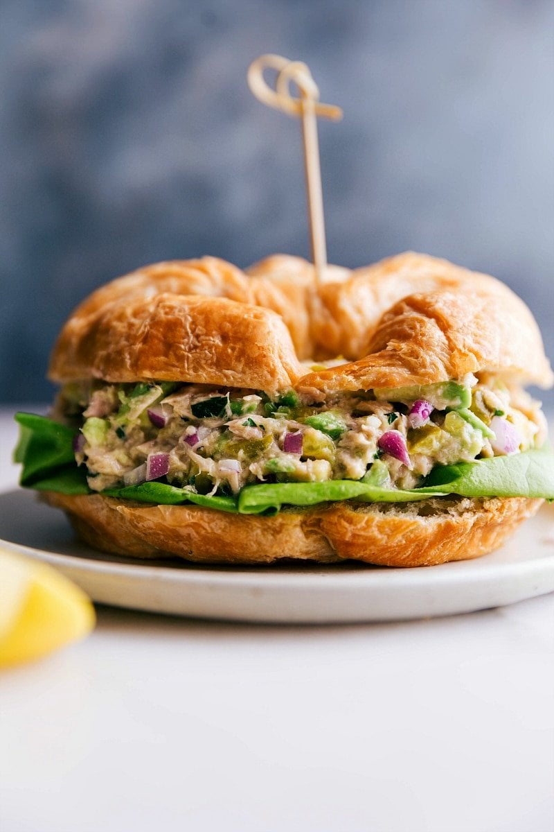 Up close image of Avocado Tuna Salad in a croissant ready to be eaten.