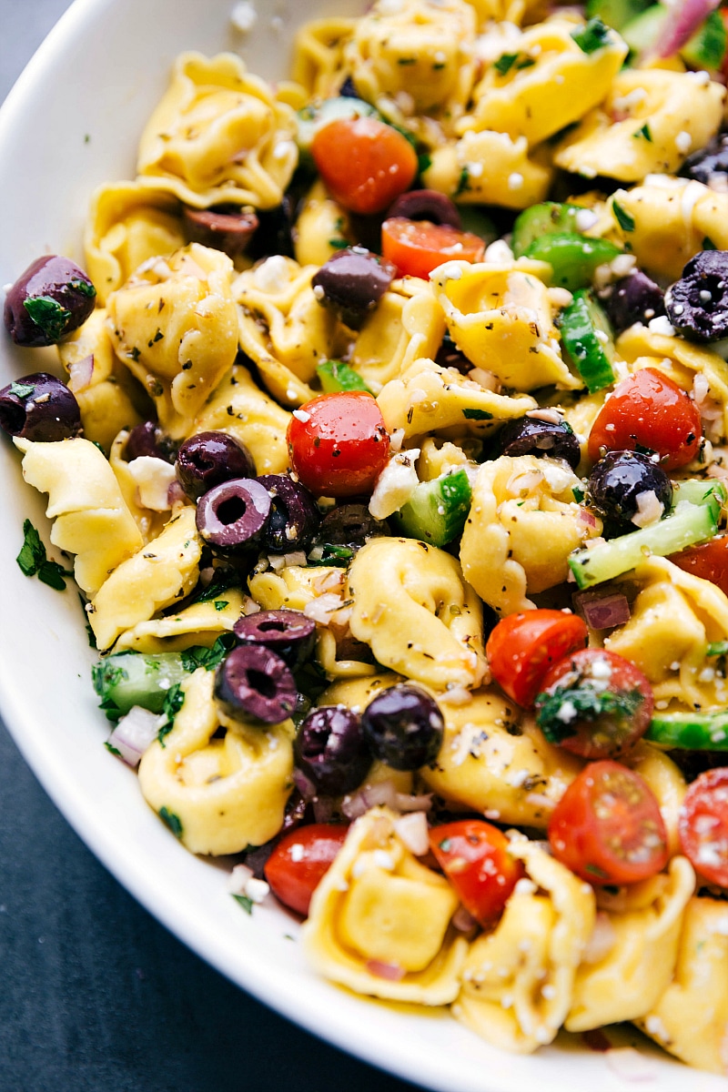 Up- close image of Greek Tortellini Salad, dressed and ready to be eaten