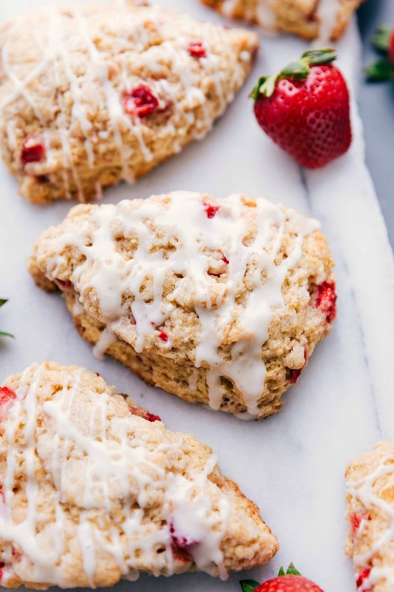 Freshly baked strawberry scones with glaze on top, ready to be enjoyed.