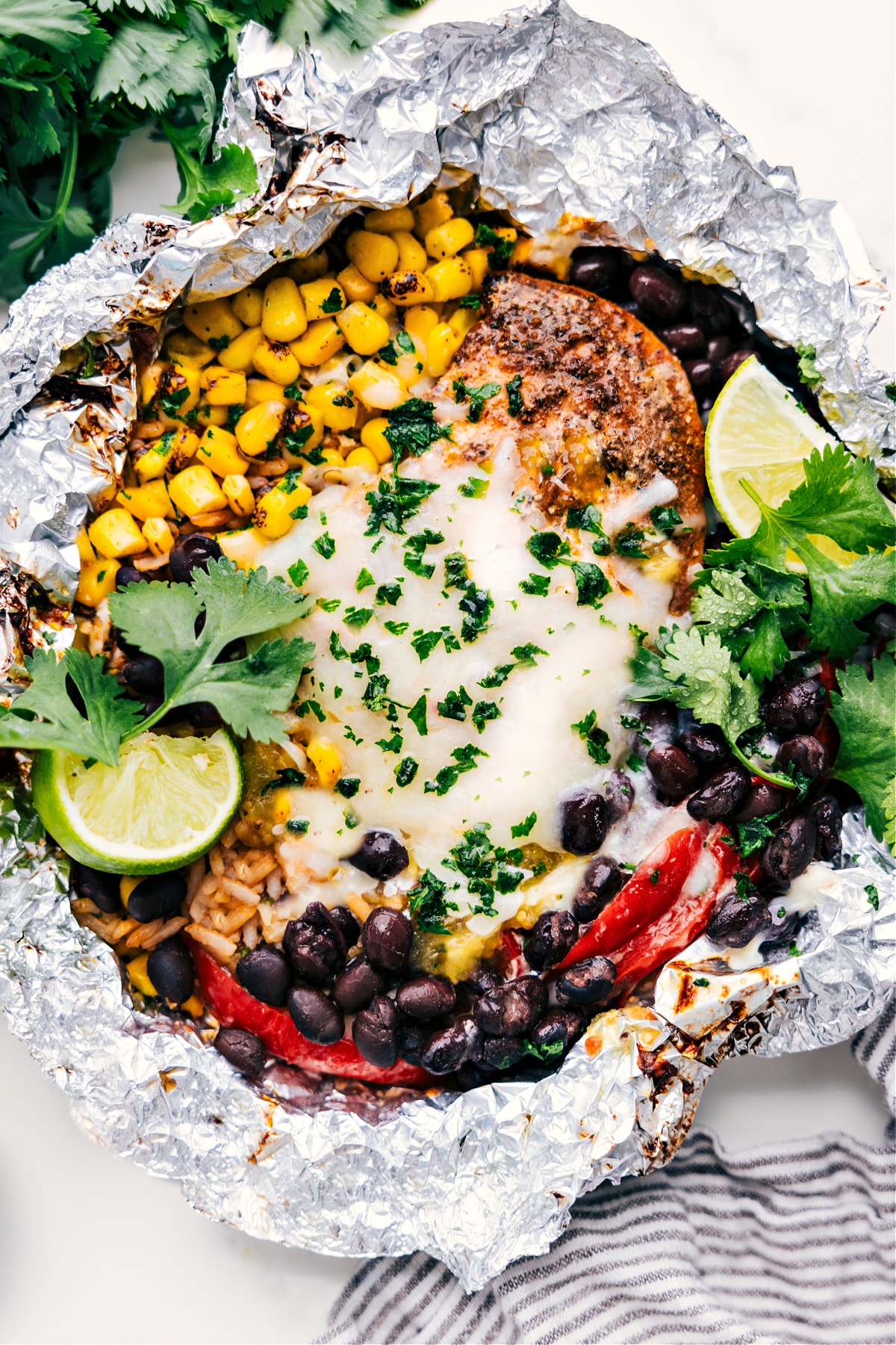 Chicken Rice Foil Packs just out of the oven, topped with melted cheese and ready to eat.