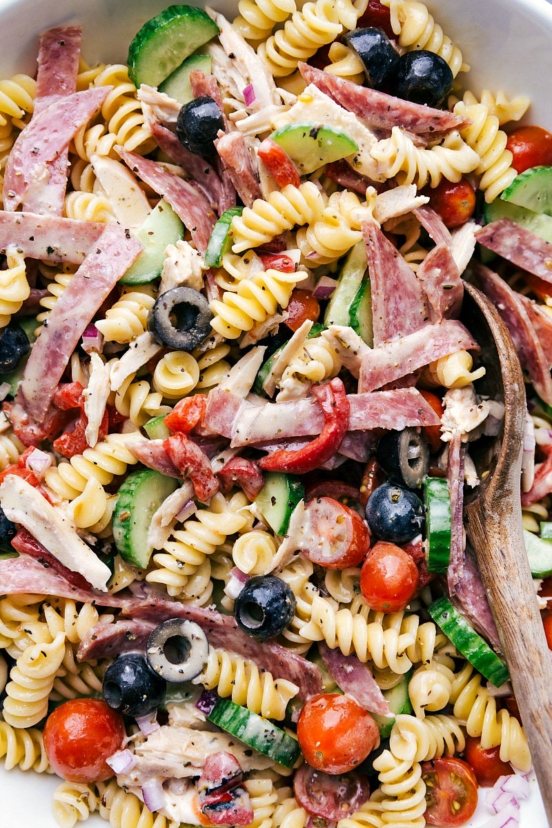 Finished pasta salad with italian dressing, richly dressed and displaying a variety of healthy, complementary flavors.