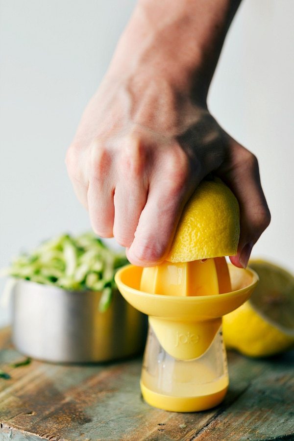 A lemon being squeezed to extract fresh juice.