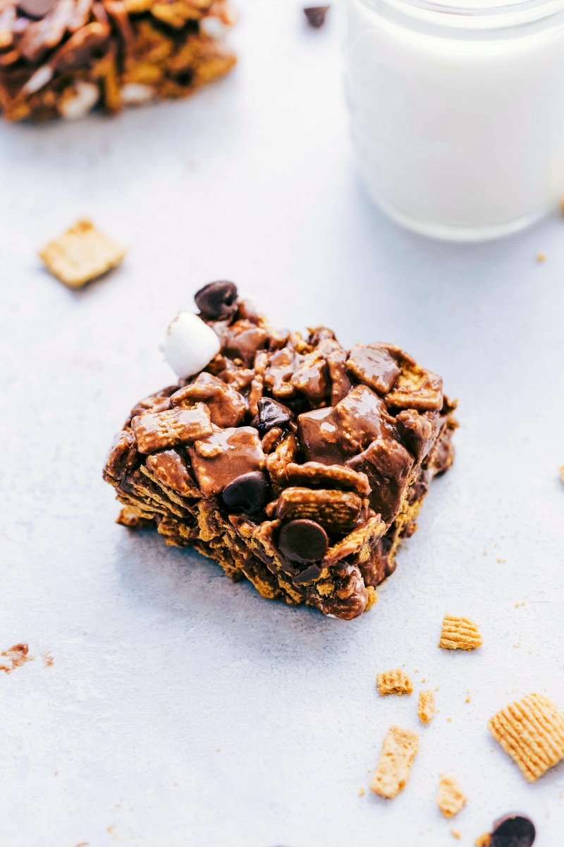 S'mores bar packed with chocolate chips and marshmallows, served alongside a glass of milk.