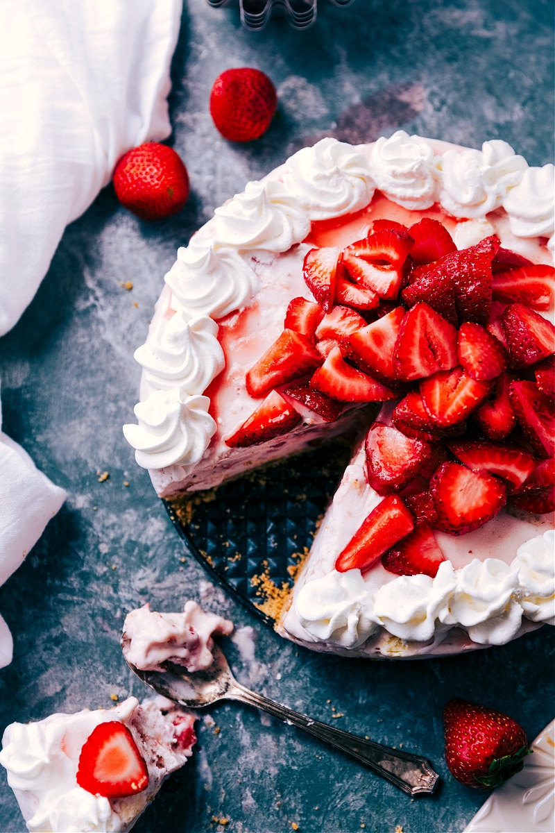 Strawberry Cheesecake Ice Cream Cake topped with fresh strawberries.