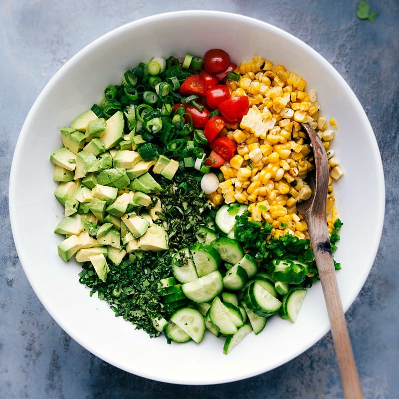 Overhead image of all the ingredients in Corn Salad in a bowl ready to be mixed together.