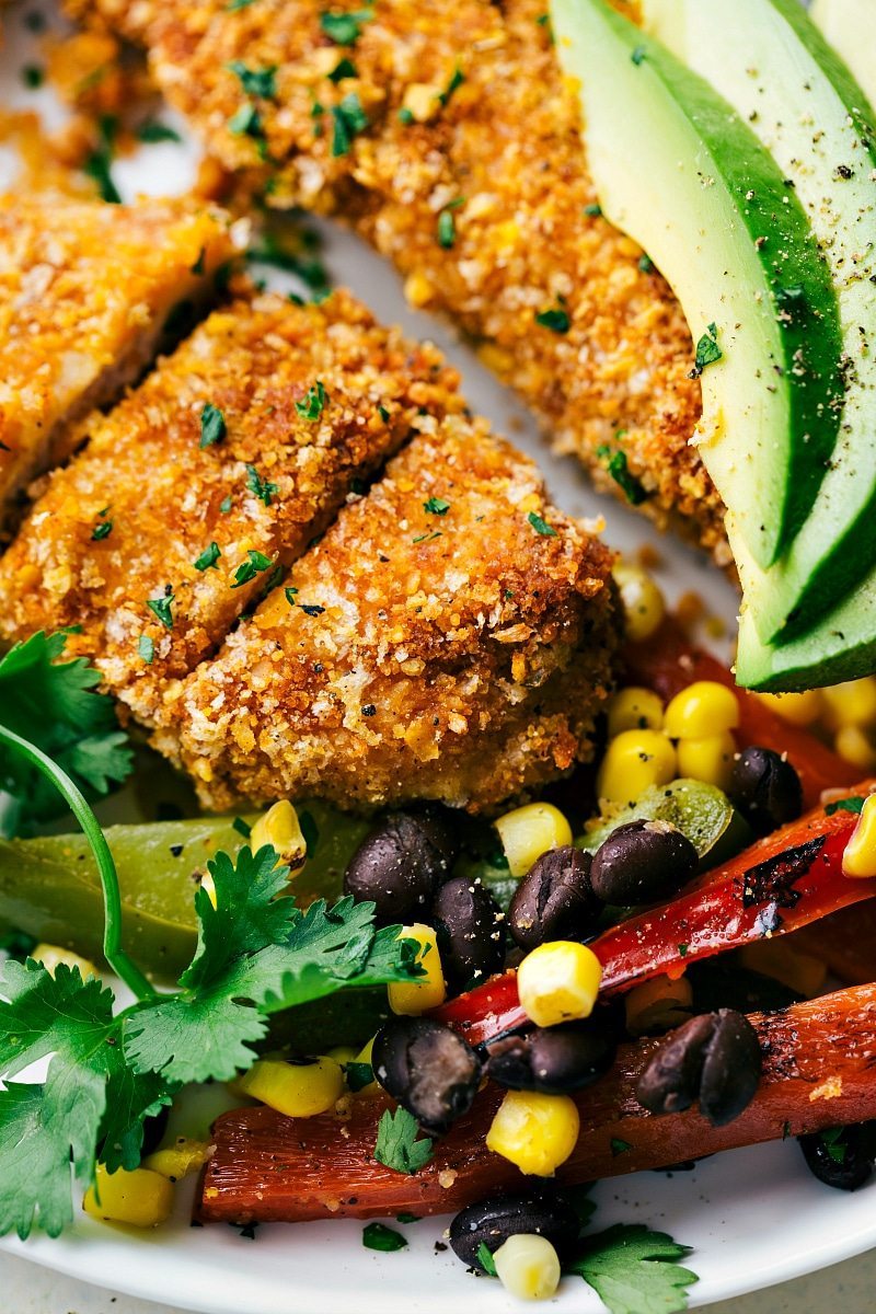 ONE PAN for this Mexican tortilla crusted chicken baked on one pan with plenty of veggies! A delicious, hearty, and healthy meal the whole family will love!