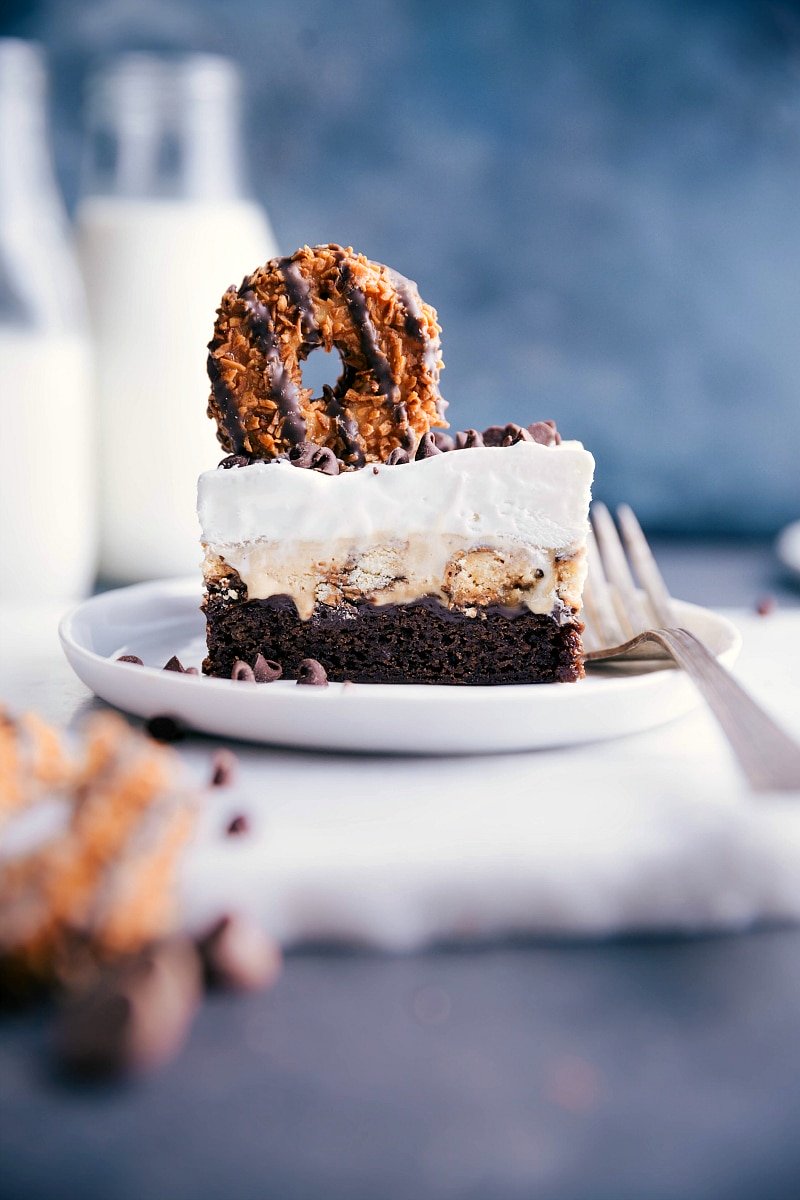 Image of one slice of the Brownie Ice Cream Bars with a Samoas cookie on top and a fork on the side.