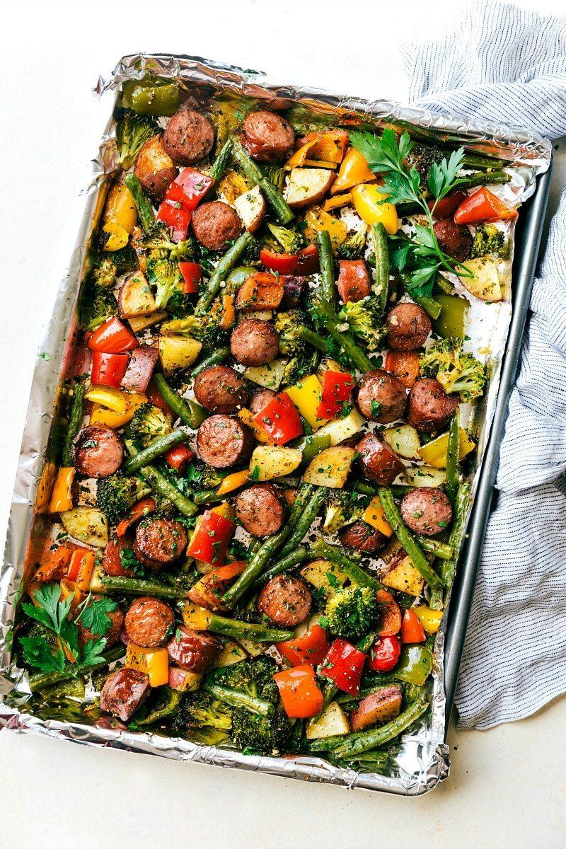Up close overhead image of the sheet pan sausage and veggies on a foil lined pan