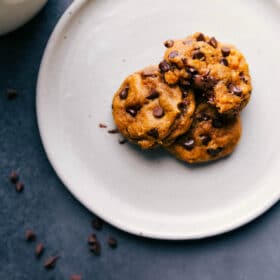 Soft pumpkin cookies on a plate with warm, melting chocolate chips, delicious and ready to be eaten.