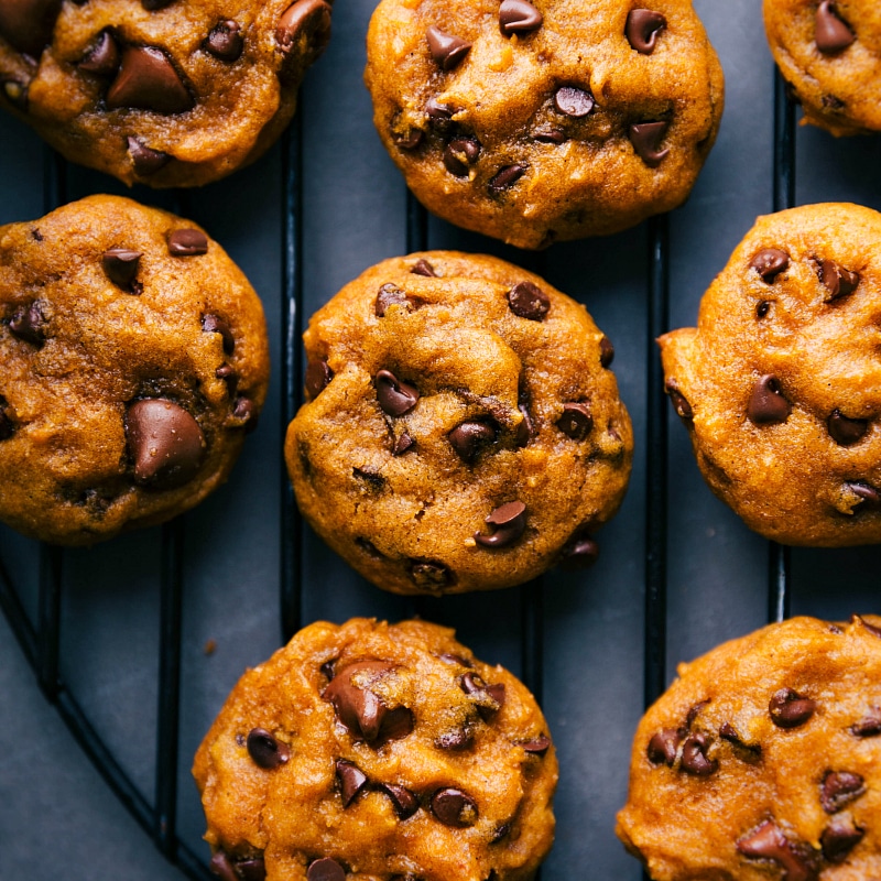 Delicious soft pumpkin chocolate chip cookies on a cooling rack.