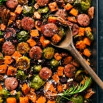 Tray of harvest vegetables and sausage, cooked and seasoned to perfection, ready to serve.